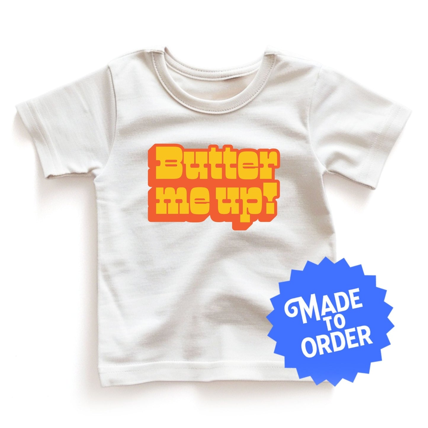 Chunky Deli product image: White "Butter Me Up" toddler/kids t-shirt with short sleeves. The text "Butter Me Up" is printed in orange and red across the front.