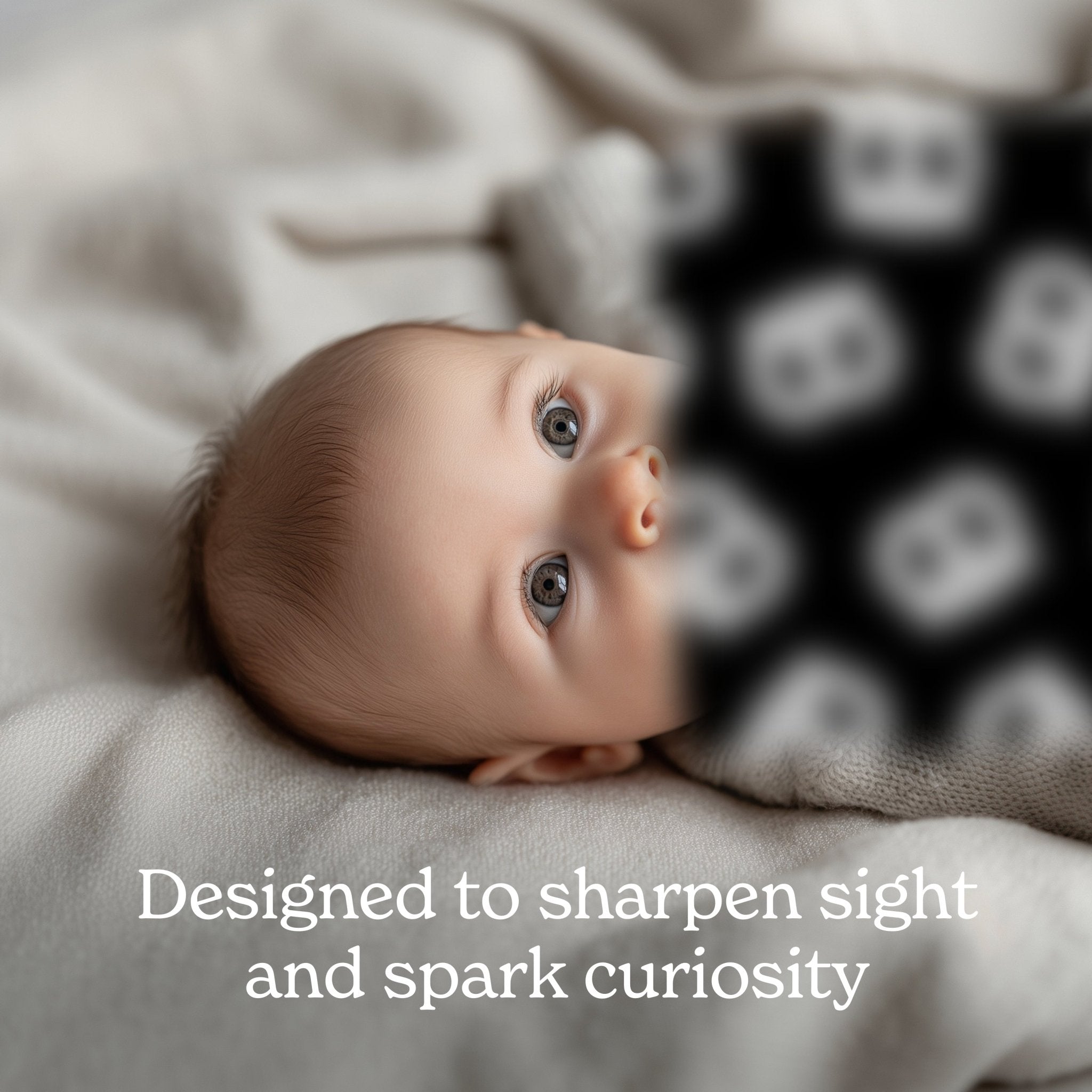 Newborn baby with big gray eyes stares at a blurry, black and white pattern with the caption: “Designed to sharpen sight and spark curiosity.”