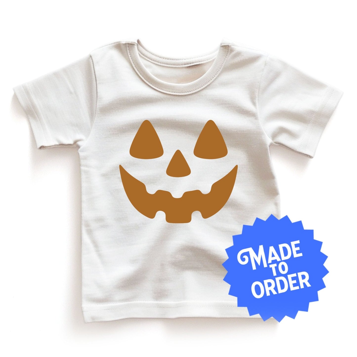 Chunky Deli product image: White "Pumpkin Smile" kids' t-shirt with a festive jack-o'-lantern face design for Halloween.