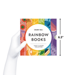 A hand holds a 6.3-inch square book with the cover for the "Chunky Deli Rainbow Books" Fancy Flavors Collection. The cover features a rainbow of food illustrations.