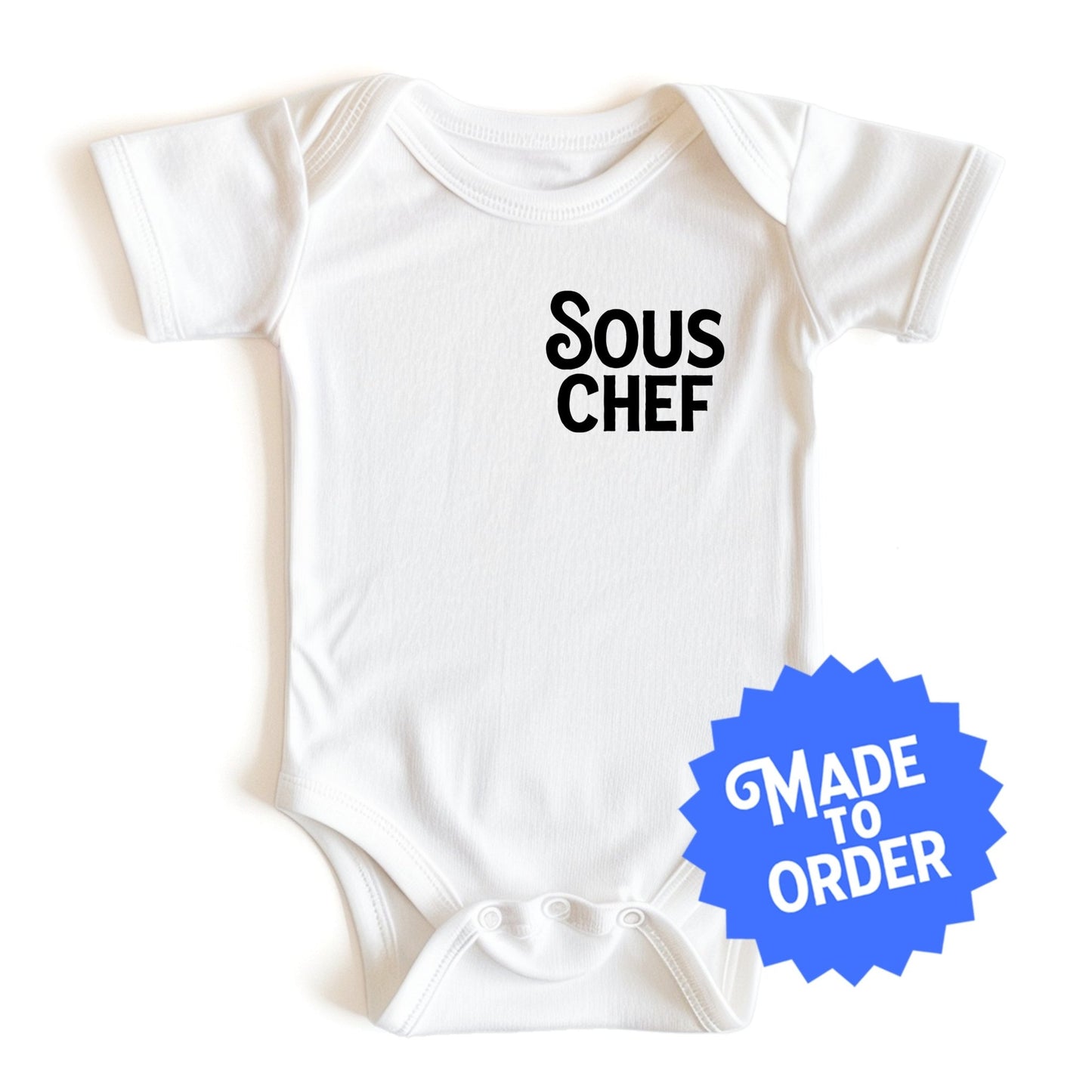 Chunky Deli product image: White-colored "Sous Chef" bodysuit (100% cotton) laid flat on a white background, showcasing the envelope shoulders and three-snap closure.