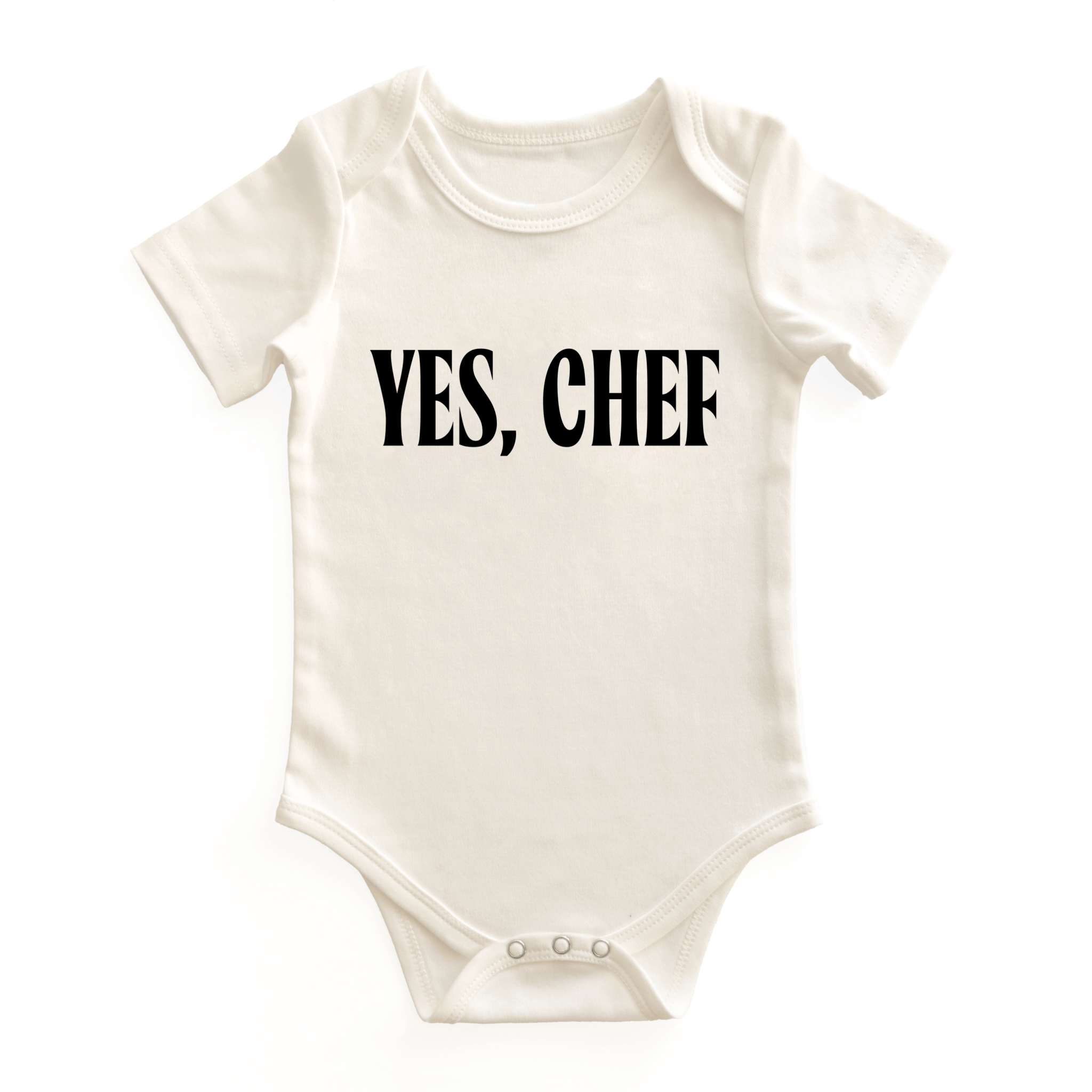 Chunky Deli baby bodysuit made from 100% cotton, short sleeve, beige/natural color with bold black text reading 'YES, CHEF' on the chest. Features envelope neckline and snap closure for easy changes.