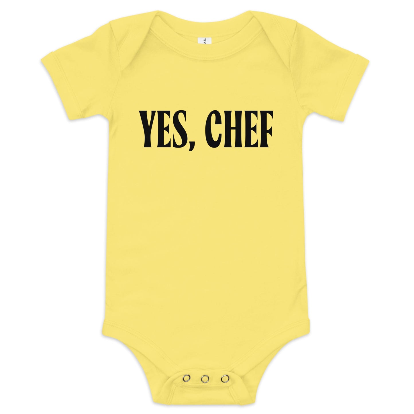 Chunky Deli product image: "Yes, Chef" onesie (100% cotton, yellow color) laid flat on a white background, showcasing the envelope shoulders, short sleeves, three-snap closure, and the text "Yes, Chef" printed in black across the chest.