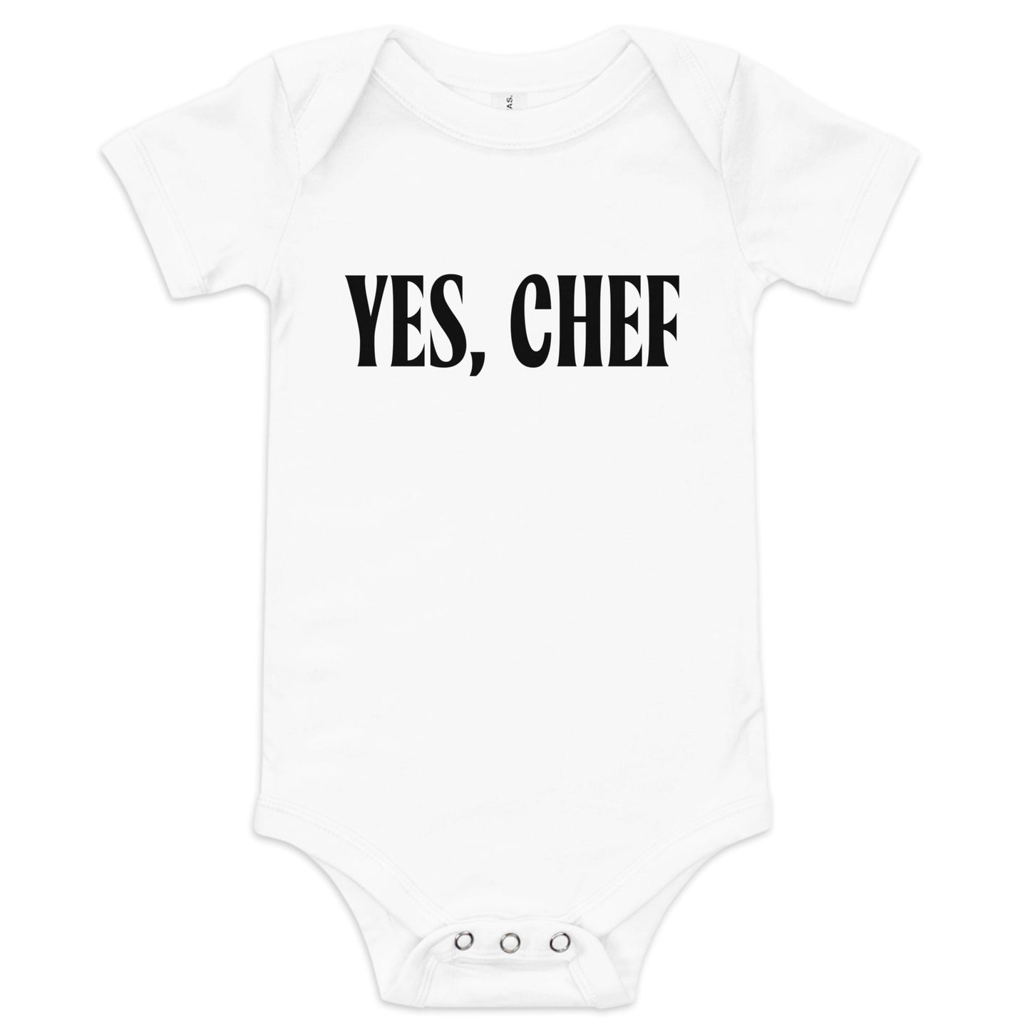 Chunky Deli product image: "Yes, Chef" onesie (100% cotton, natural color) laid flat on a white background, showcasing the envelope shoulders, short sleeves, three-snap closure, and the text "Yes, Chef" printed in black across the chest.