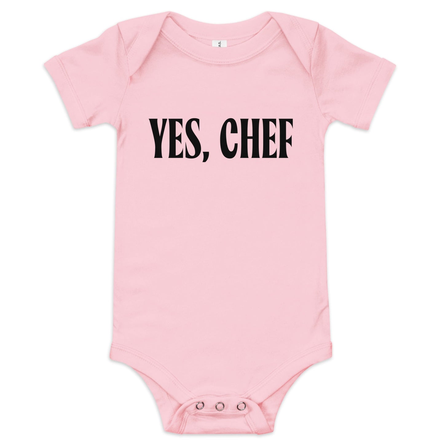 Chunky Deli product image: "Yes, Chef" onesie (100% cotton, pink color) laid flat on a white background, showcasing the envelope shoulders, short sleeves, three-snap closure, and the text "Yes, Chef" printed in black across the chest.