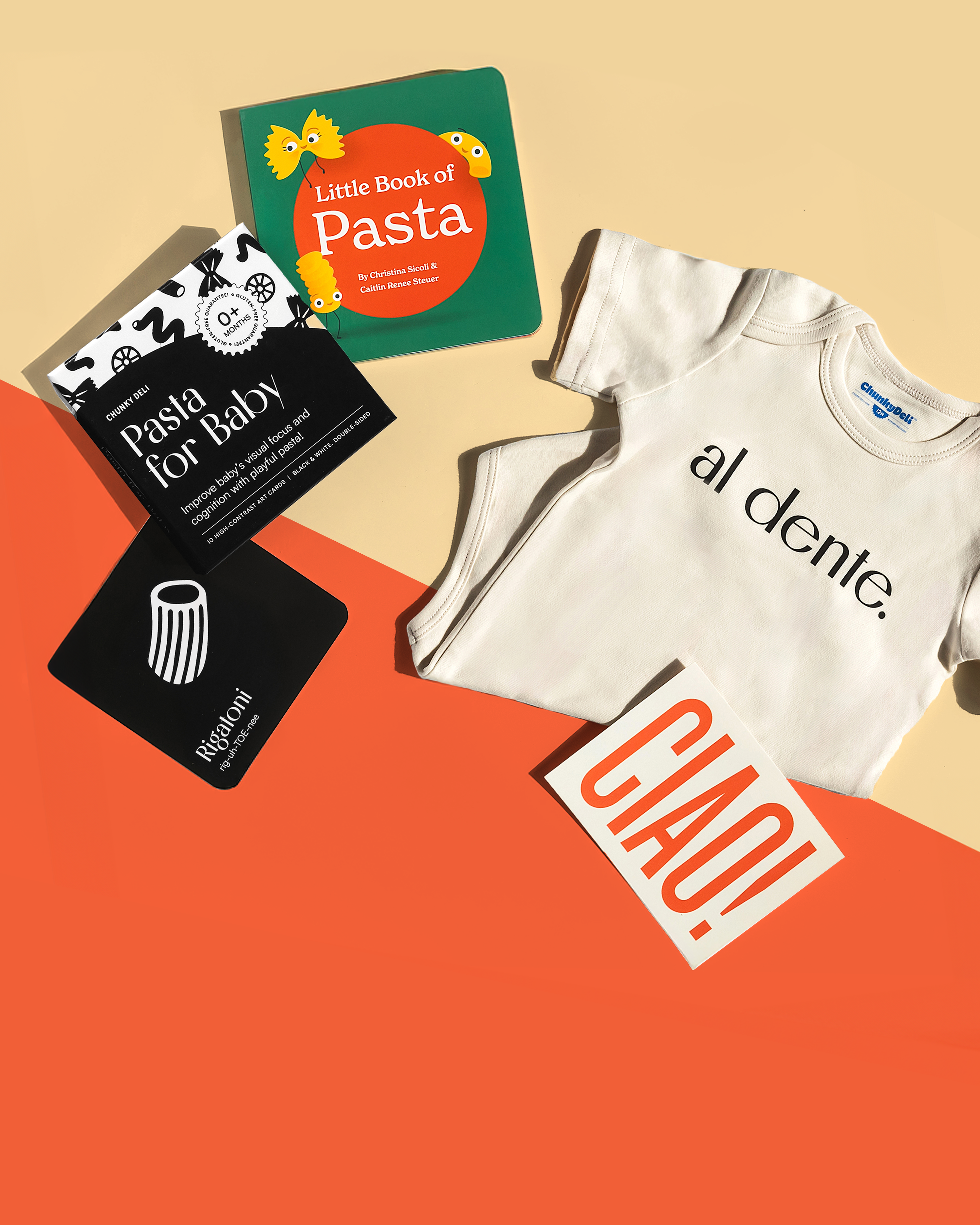A pasta-themed baby gift set with high-contrast Pasta for Baby art cards and a colorful board book, a onesie that reads "al dente," and a "CIAO" card