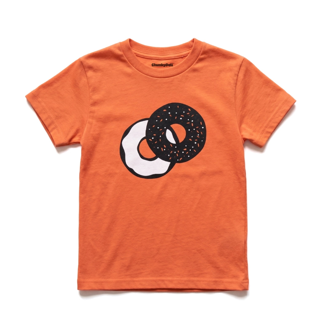 Chunky Deli product image: Toddler tee in 100% cotton, short sleeve, orange color. Features a graphic illustration of everything bagel with cream cheese in 2 colors, black and white, centered on the chest.