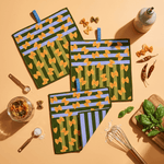 Chunky Deli product image of three green pot holders with yellow bowtie pasta patterns on a beige surface with kitchen items.