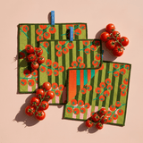 Chunky Deli product image of a set of three green cleanup cloths with red tomato pattern on a pink background