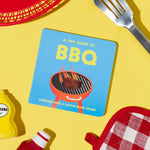 A Tiny Guide to BBQ book cover, on a yellow background with a red basket, mustard, ketchup, grill spatula, and oven mitt. From Chunky Deli Written by Christina Krol & Caitlin Renee Steuer