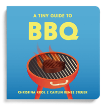 Chunky Deli product Image. The bright blue cover of the board book 'A Tiny Guide to BBQ' showcases a bold yellow title above a classic red grill with cartoon flames and a steak. Authors Caitlin Renee Steuer and Christina Krol.