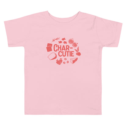 Chunky Deli product image: Pink short-sleeved kids' and toddler t-shirt with the text "Charcutie" in orange font, surrounded by illustrations of charcuterie board foods, on the chest.