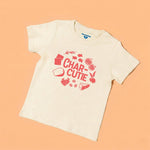 Chunky Deli product image: Toddler tee in 100% cotton, short sleeve, nude color. Features a stylized graphic with the text "Char-Cutie" surrounded by vibrant illustrations of crackers, cheese, berries, olives, figs, and goldfish.
