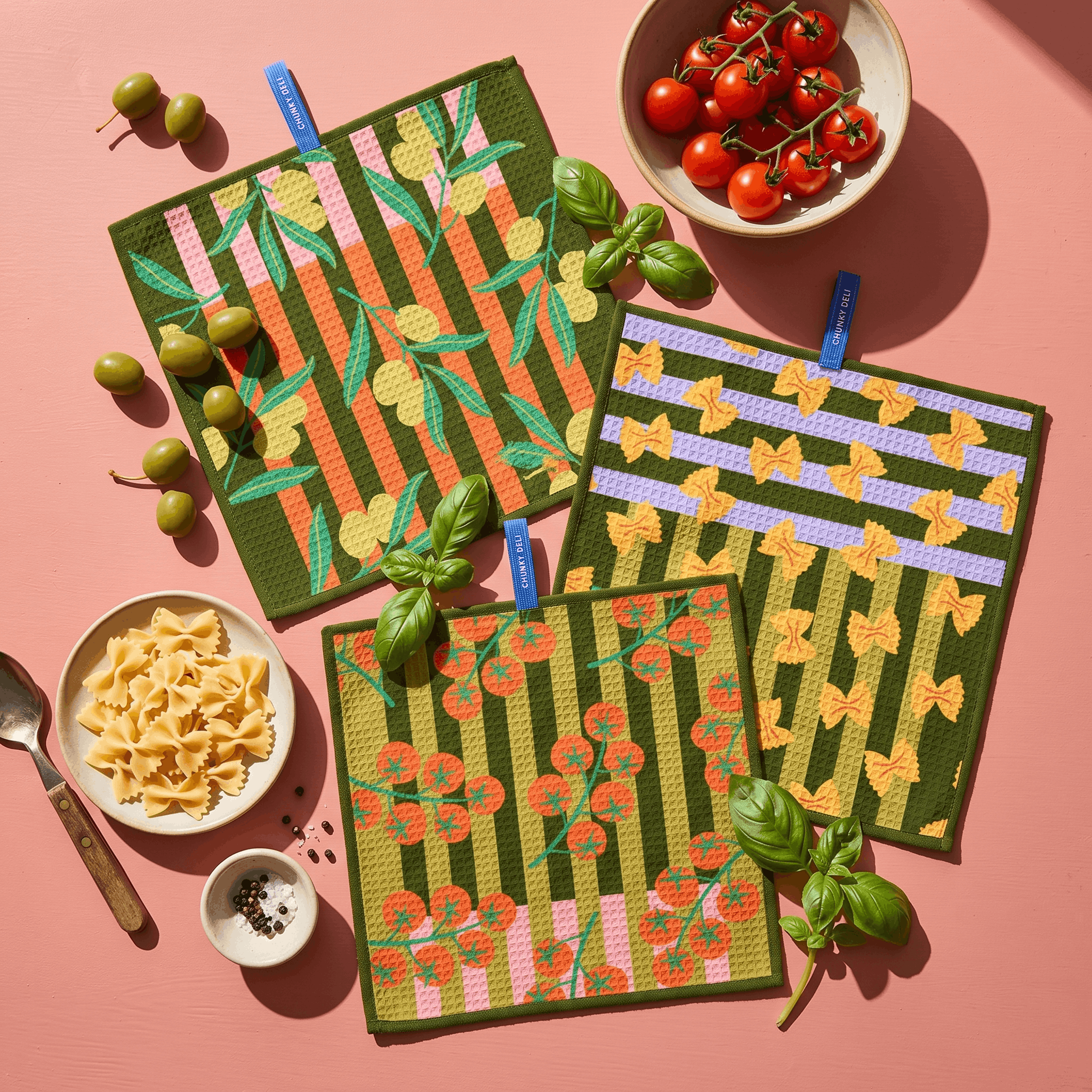 Chunky Deli product image of a set of three patterned cloths on a pink background with food items.