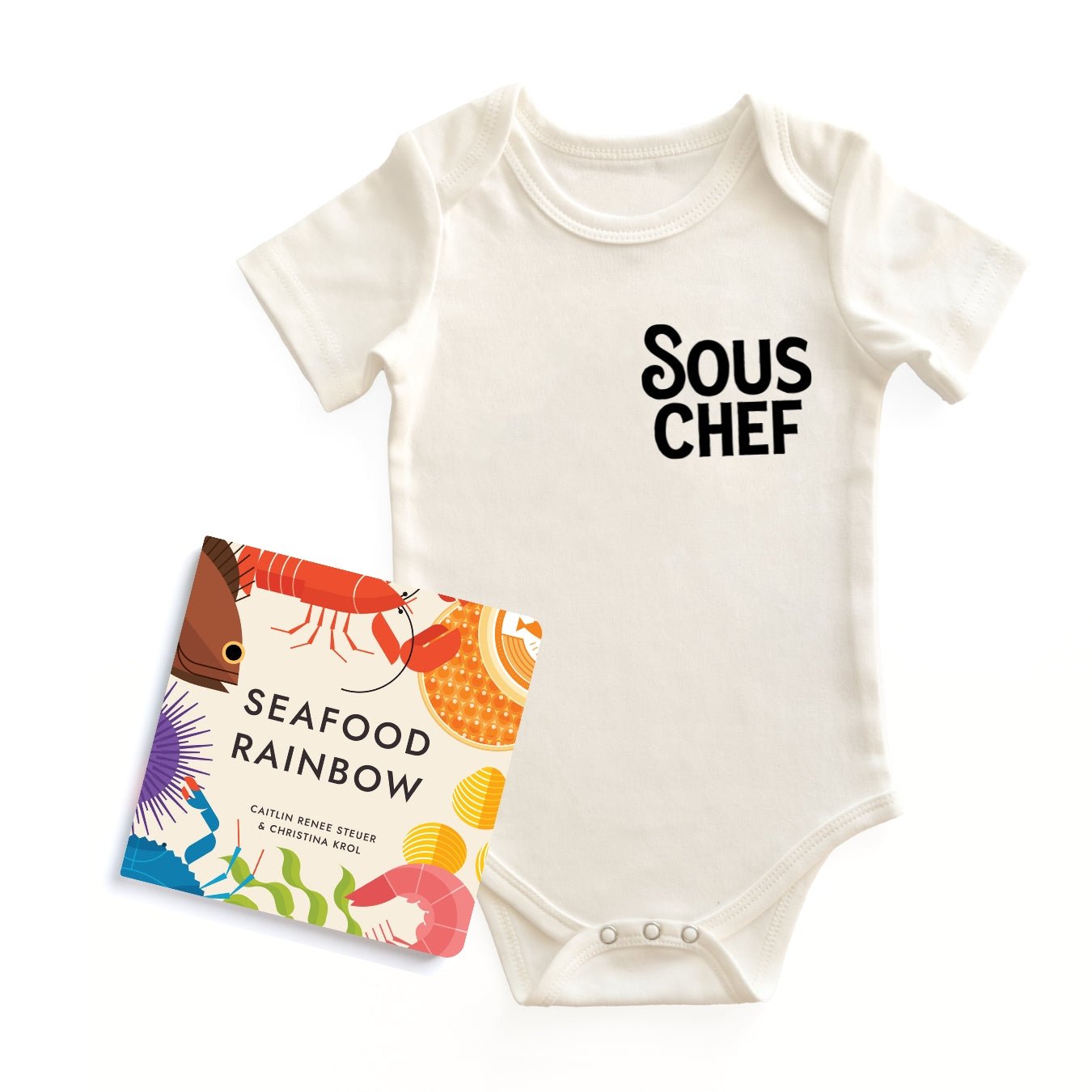  Chunky Deli "Sous Chef Starter Pack" featuring a white, 100% cotton, short sleeve baby bodysuit with black text "SOUS CHEF", accompanied by the "Seafood Rainbow" board book by Caitlin Renee Steuer & Christina Krol, all on a white background.