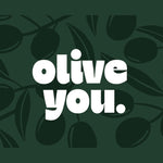 Chunky Deli product image: Green greeting card with the pun "Olive You" (referencing the olive fruit) and dark illustrations of olives, laid flat on a white background.