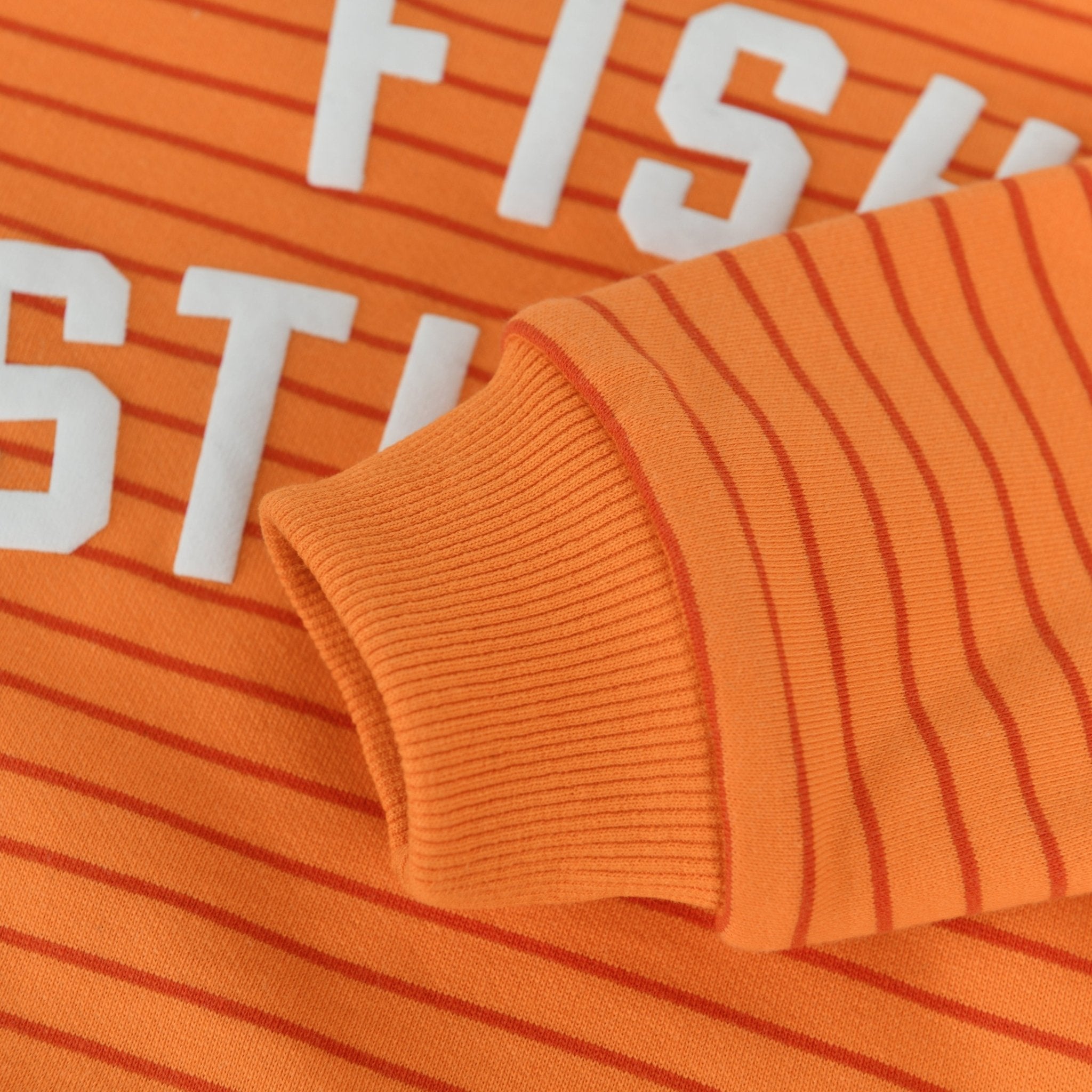 Fish Sticks Kids Crewneck Sweater with vibrant orange stripes and soft cotton fabric.