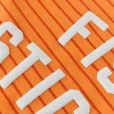 Close-up of the vibrant orange striped fabric and lettering on the Fish Sticks Kids Crewneck Sweater.
