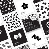 Chunky Deli product image: "Pasta for Baby" high-contrast black and white art cards box cover in the center, surrounded by example cards arranged in a grid format to showcase the front and back of each design. White background.