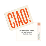  A high-angle flat lay of two thank you cards. The top card is peach-colored with the word "CIAO!" in large, orange letters. The bottom card is white with the text "We're so excited to meet the new addition! - Rachel & Mark" and a QR code.