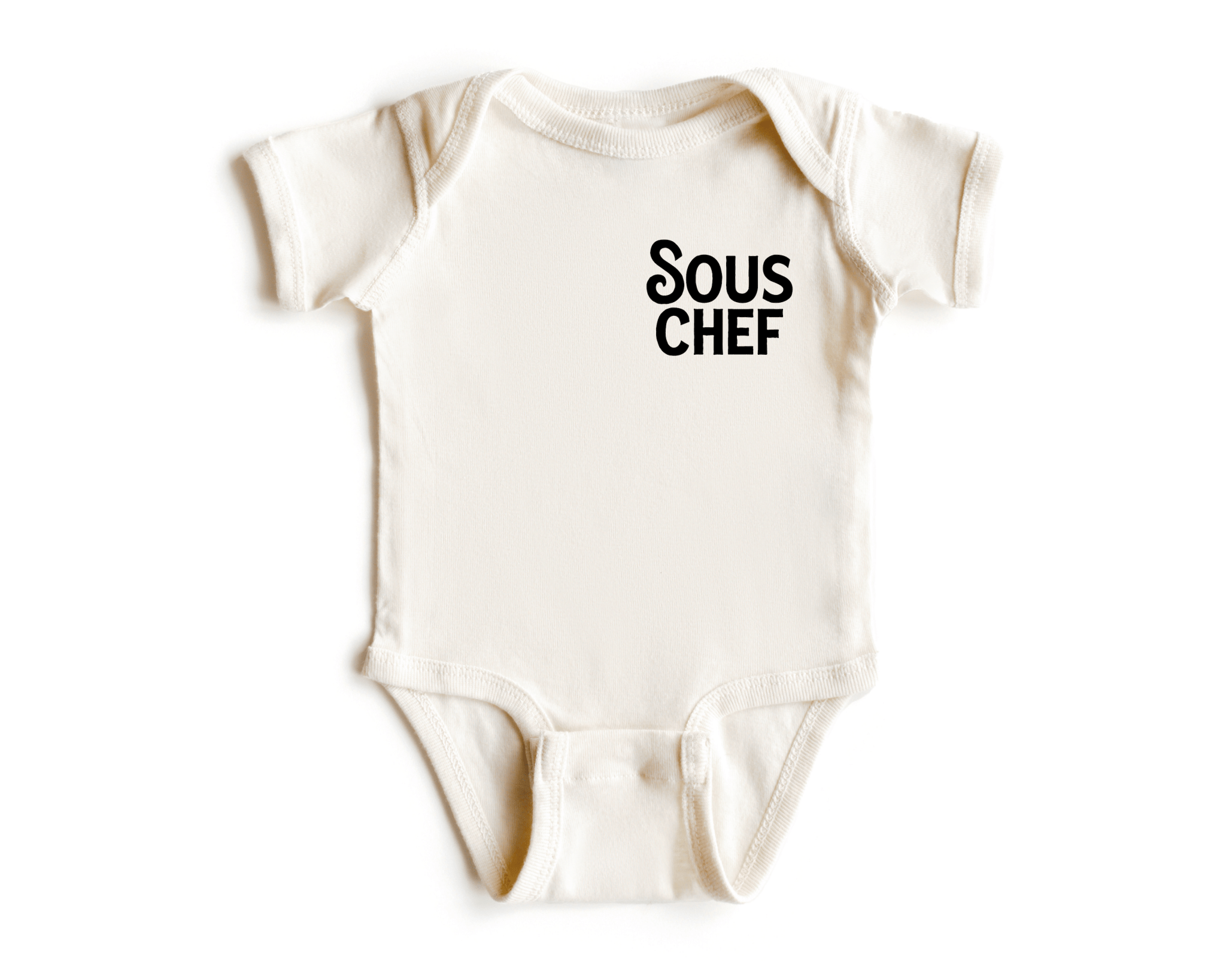 Chunky Deli product image: Natural-colored "Sous Chef" bodysuit (100% cotton) laid flat on a white background, showcasing the envelope shoulders and three-snap closure.