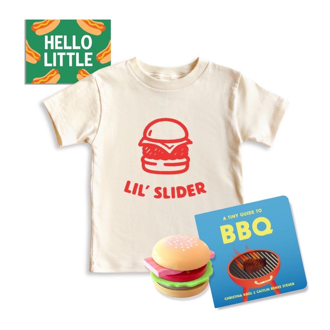Grill master Toddler Gift bundle | Chunky deli product image containing "Lil' Slider" Kids Tee, A tiny Guide to BBQ, A Toy burger and a hello little gift note with a hot dog theme.