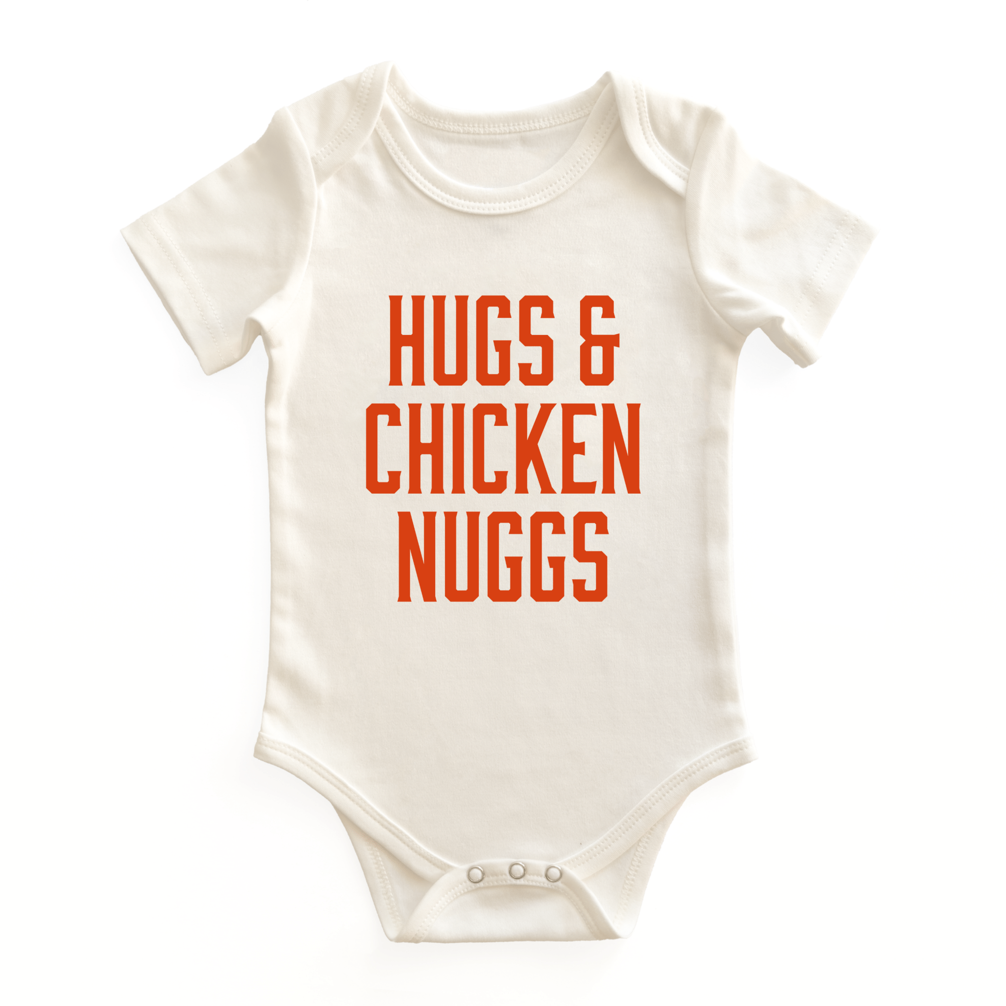 Chunky Deli baby bodysuit in 100% cotton, short sleeve, beige/natural color featuring bold orange block text reading 'Hugs & Chicken Nuggs' on the chest. Snap closure bottom, foodie-themed infant apparel.