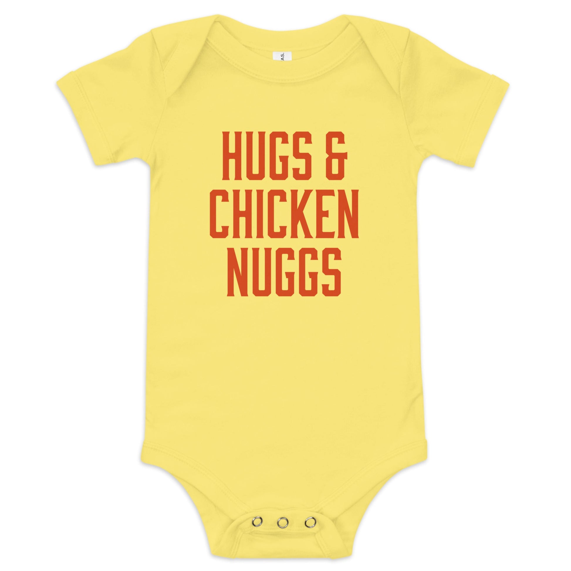 Chunky Deli product image: "Hugs and Chicken Nugs" bodysuit (100% cotton, yellow color) laid flat on a white background, showcasing the envelope shoulders, short sleeves, three-snap closure, and the text "Hugs and Chicken Nugs" in orange font on the chest