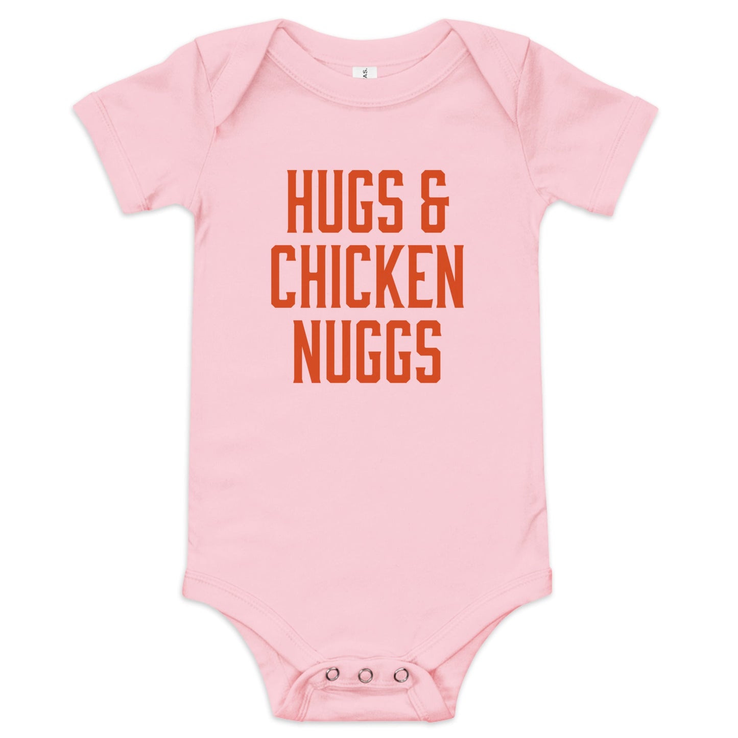 Chunky Deli product image: "Hugs and Chicken Nugs" bodysuit (100% cotton, pink color) laid flat on a white background, showcasing the envelope shoulders, short sleeves, three-snap closure, and the text "Hugs and Chicken Nugs" in orange font on the chest.