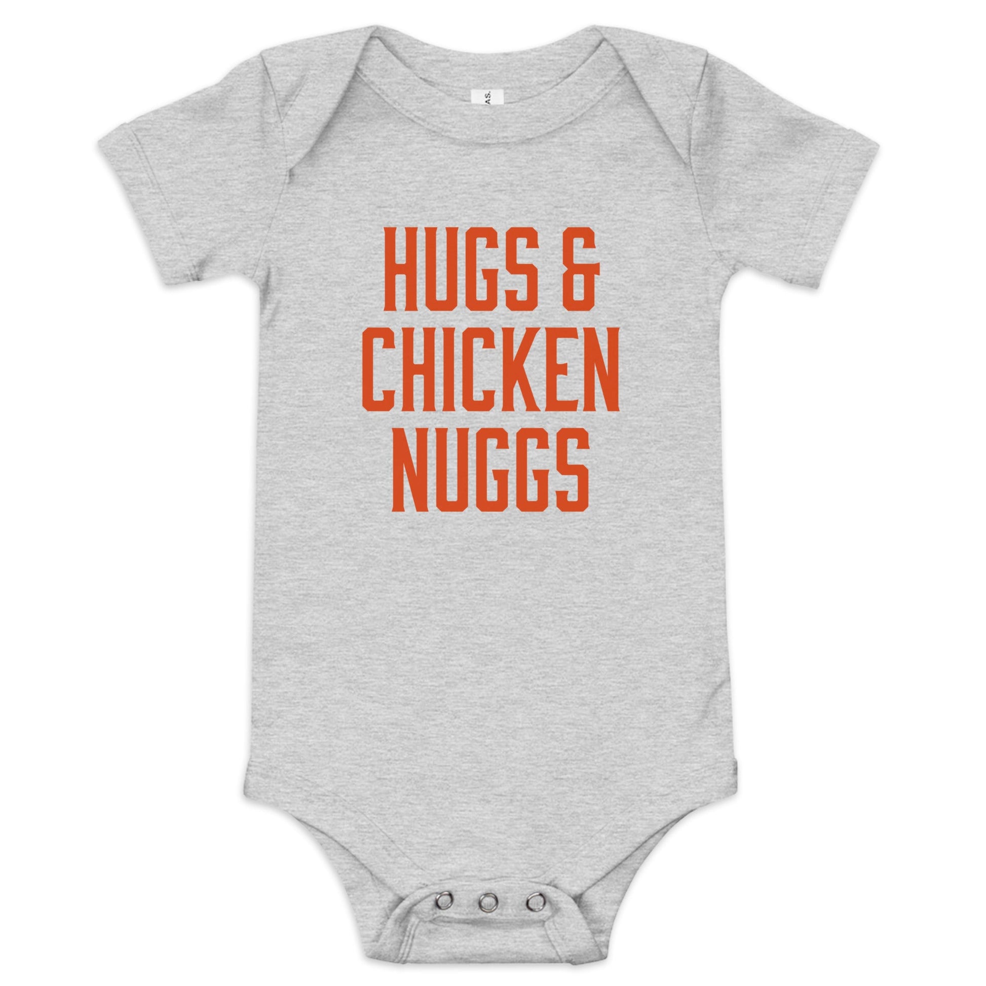 Chunky Deli product image: "Hugs and Chicken Nugs" bodysuit(100% cotton, grey color) laid flat on a white background, showcasing the envelope shoulders, short sleeves, three-snap closure, and the text "Hugs and Chicken Nugs" in orange font on the chest.