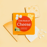Chunky Deli product photo: "Little Book of Cheese" (orange cover with red spot, title, authors, and feta, swiss, and gorgonzola illustrations) displayed on a bed of real cheeses against a peach background.