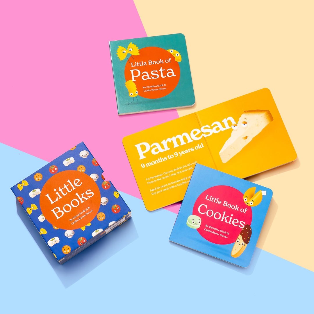 Chunky Deli Product Image : Little Books: Starter Collection lifestyle shot - A blue patterned slipcase sits next to open board books including Little Book of Pasta, Little Book of Cookies, and an interior page from Little Book of Cheese featuring Parmesa