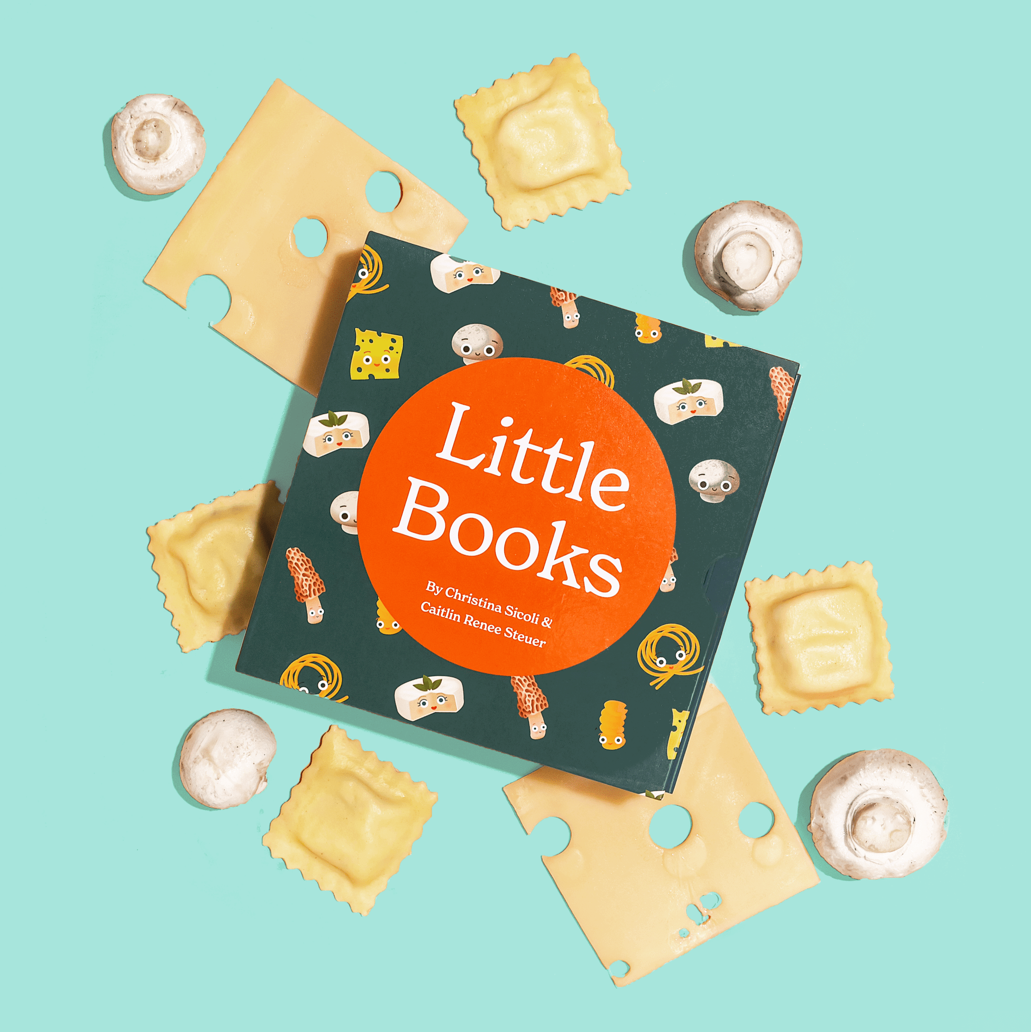 Chunky Deli product image: "Little Books Tasty Collection" box set laying on top of a bed of ravioli, mushrooms, and cheese, all placed on a light blue background.