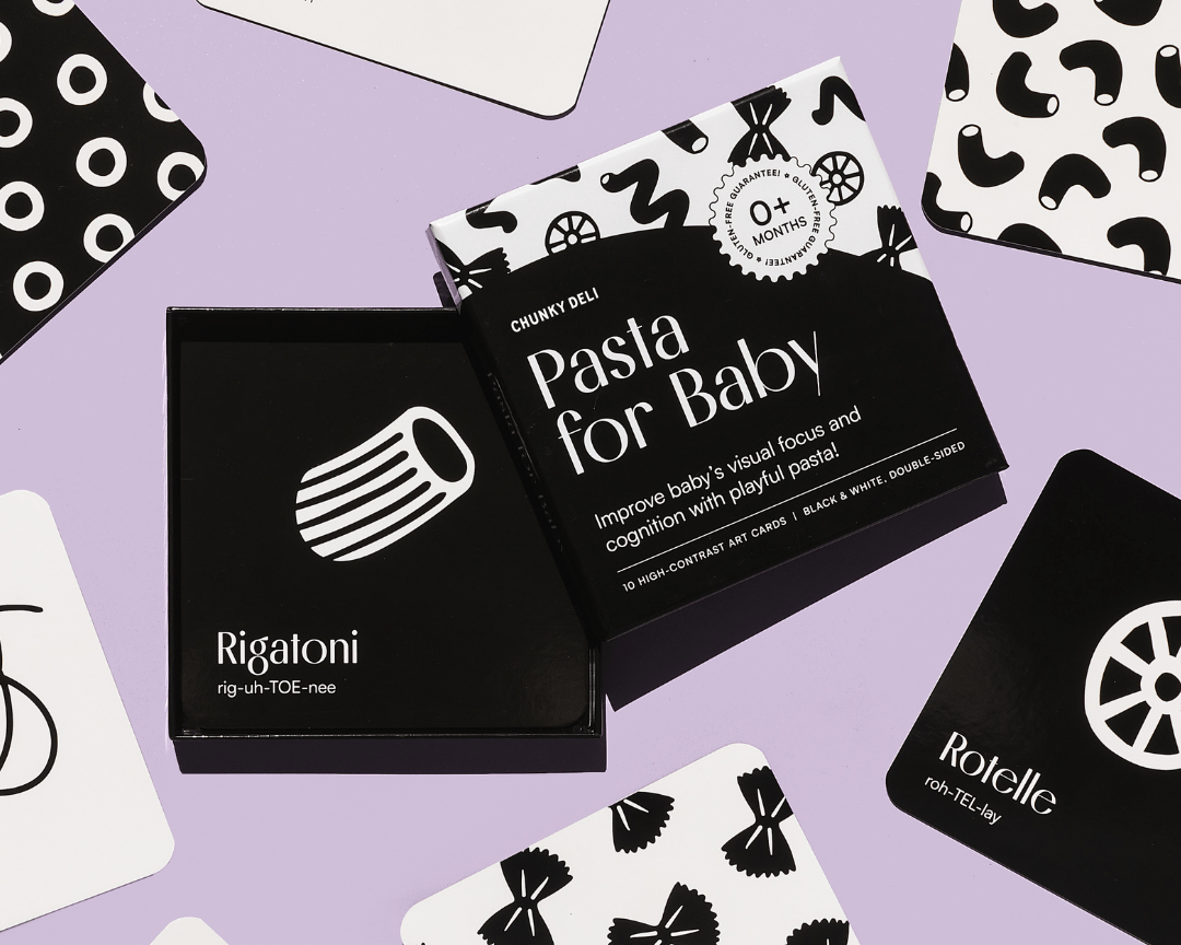 Chunky Deli product image: "Pasta for Baby" black and white art cards box (a visual stimulation and sensory play toy) on a purple background, with several example cards spread around showcasing the high-contrast designs.