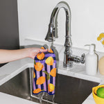 Chunky Deli product image of a person holding a colorful towel with a lemon pattern over a kitchen sink.