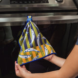 Chunky Deli product image of a person holding a colorful anchovy fish-patterned cleanup cloth in front of an oven.