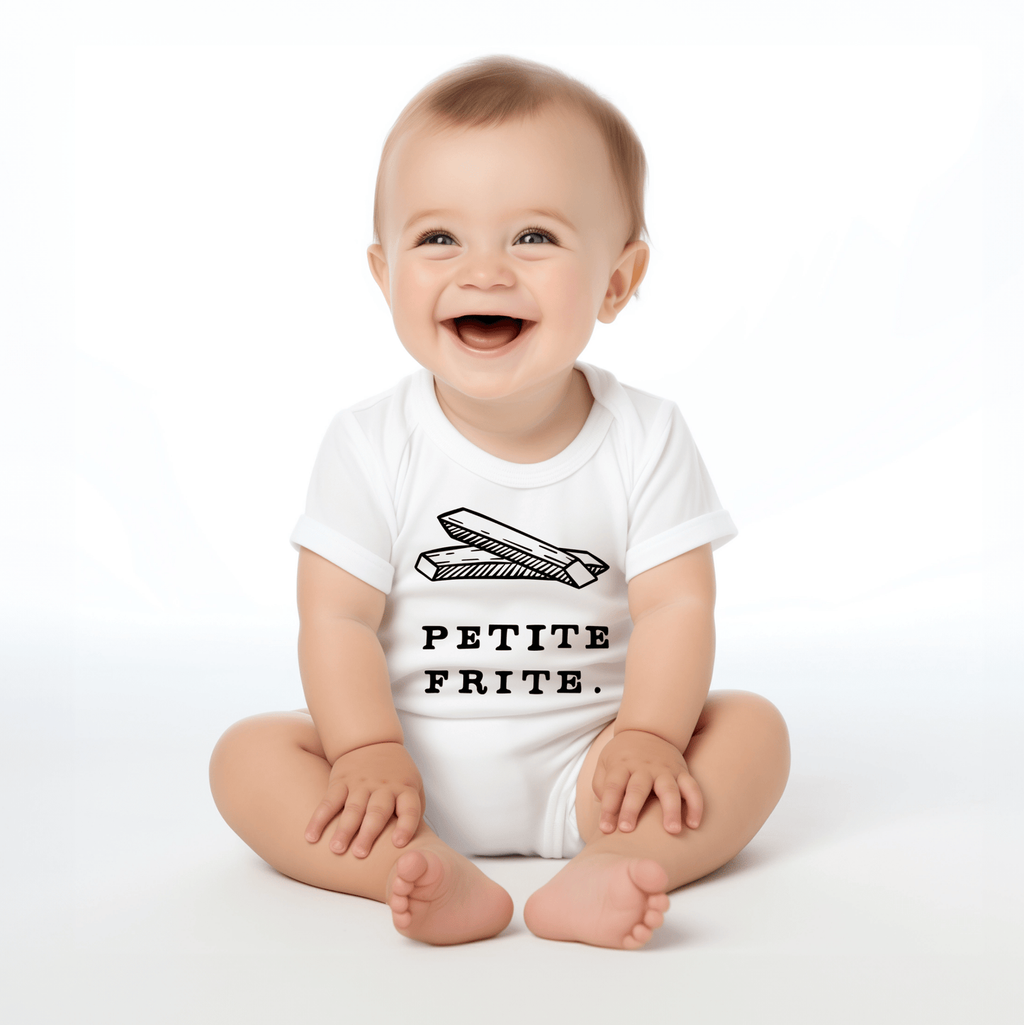 Chunky Deli product image: Happy, smiling baby wearing the "Petite Frite" bodysuit, showcasing the short sleeves, envelope shoulder, and graphic design across the chest. White background.