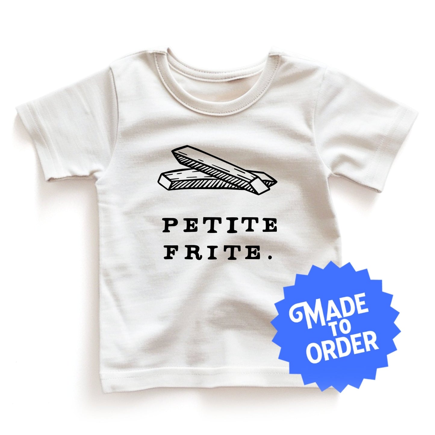 Product display image of the "Petite Frite" kids and toddler t-shirt in natural cotton, laid flat on a white background. Chunky Deli product image.