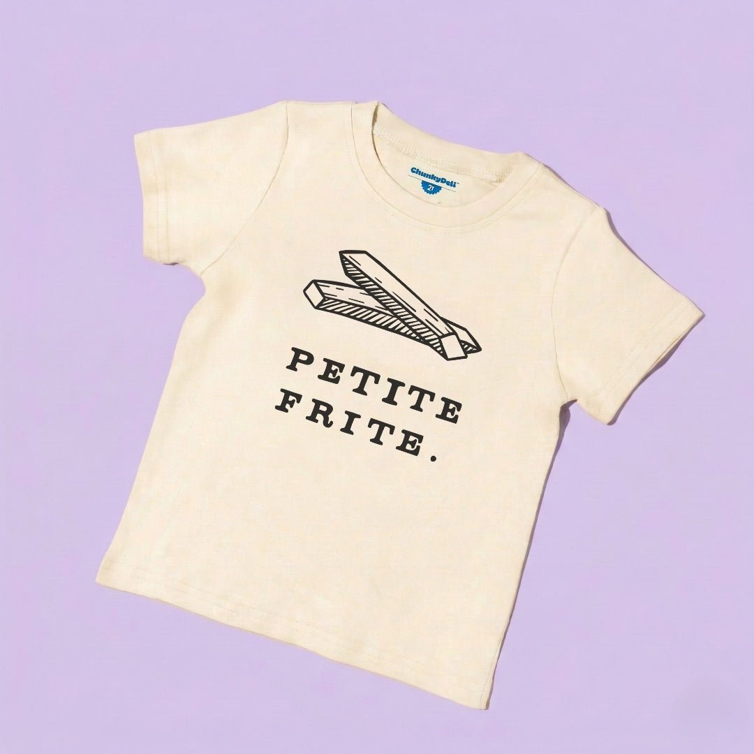 Chunky Deli product image: Toddler tee in 100% cotton, short sleeve, beige/natural color. Features a graphic illustration of fries with the text "Petite Frite" underneath, centered on the chest.