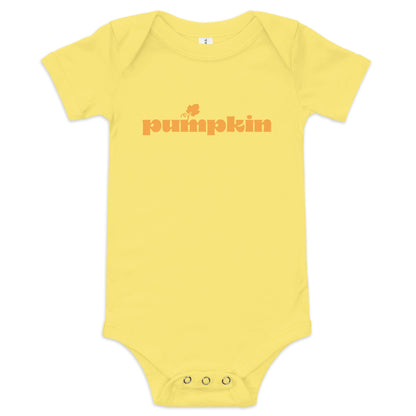 Chunky Deli product image: "Pumpkin" onesie (100% cotton, yellow color) laid flat on a white background, showcasing the envelope shoulders, short sleeves, three-snap closure, and the text "Pumpkin" printed in orange across the chest.