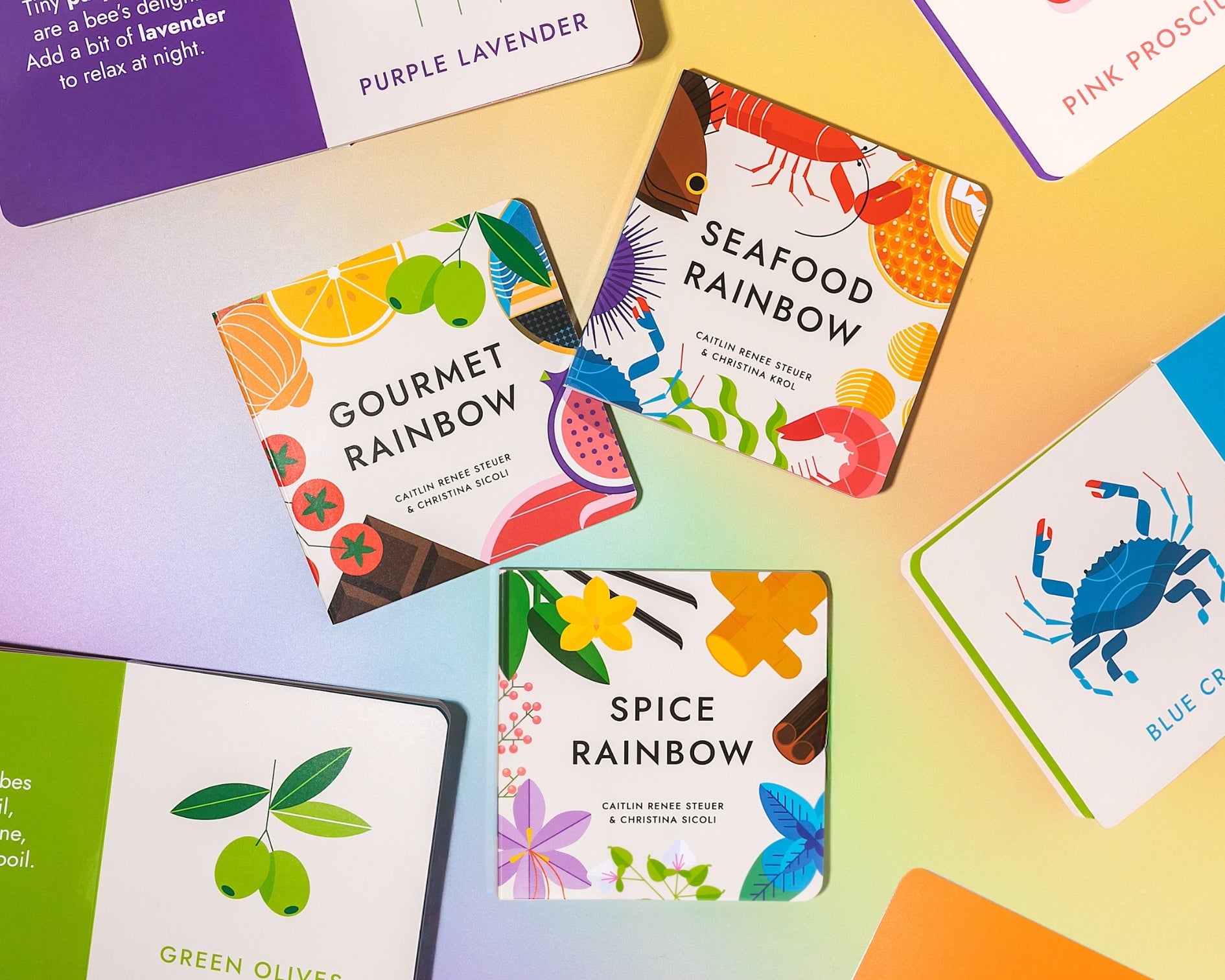  Chunky Deli "Fancy Flavors Collection" featuring five small hardcover books: "Gourmet Rainbow" by Caitlin Renee Steuer & Christina Sicoli, "Spice Rainbow" by Caitlin Renee Steuer & Christina Sicoli, and "Seafood Rainbow" by Caitlin Renee Steuer & Christi