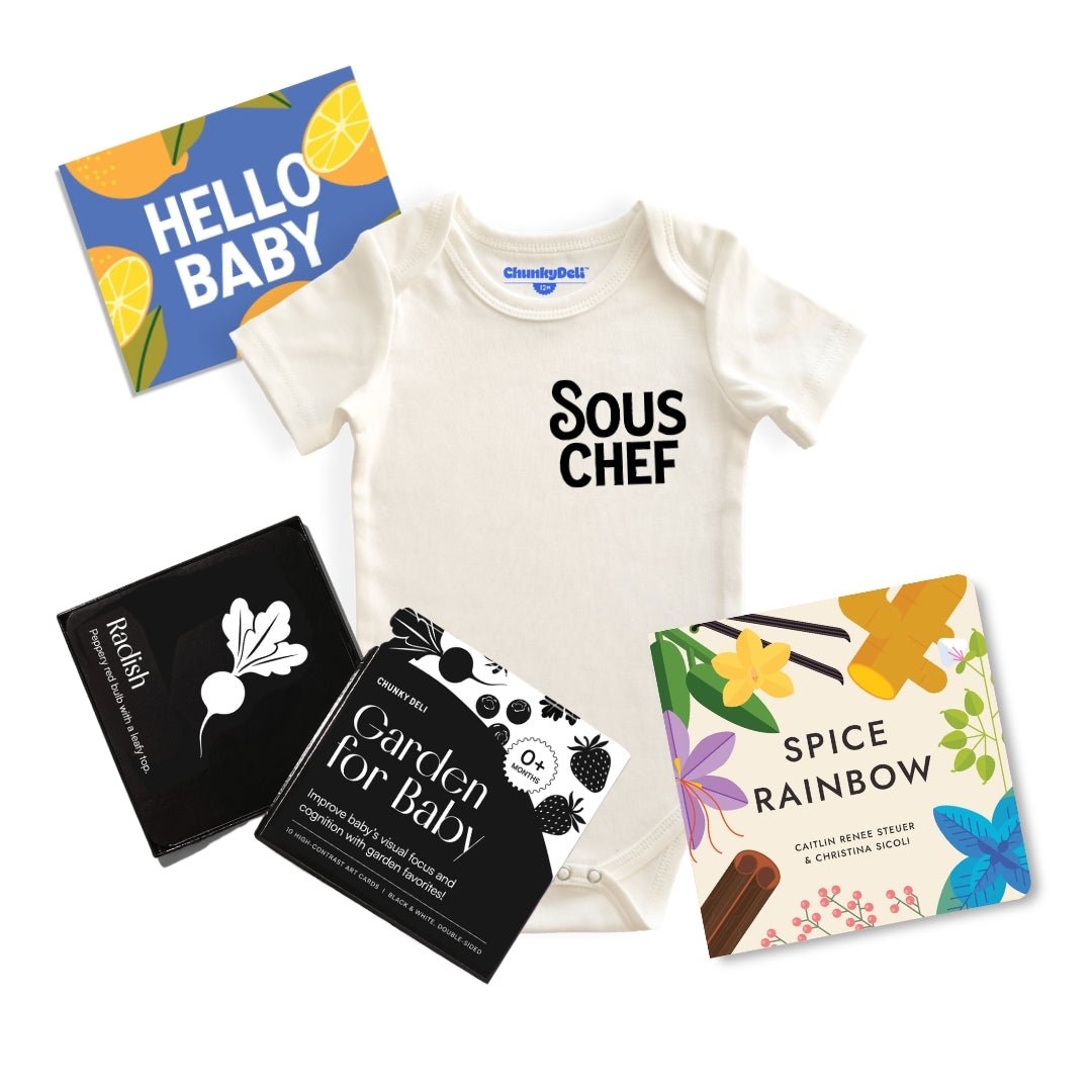Chunky Deli product: Gourmet Baby Gift Bundle, including the "Sous Chef" bodysuit (100% cotton, natural color), "Gourmet Rainbow" board book, "Gourmet for Baby" high-contrast black and white art cards for visual stimulation, and an "Hello Baby" gift note
