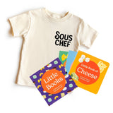 Chunky Deli "Sous Chef Starter Pack" featuring a nude, 100% cotton, short sleeve toddler tee with black text "SOUS CHEF", accompanied by the "Little Books: Culinary Collection" featuring three board books: "Little Book of Cheese," "Little Book of Cookies,