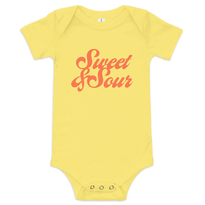Chunky Deli product image: "Sweet and Sour" onesie (100% cotton, yellow color) laid flat on a white background, showcasing the envelope shoulders, short sleeves, three-snap closure, and the text "Sweet and Sour" in orange cursive font on the chest.