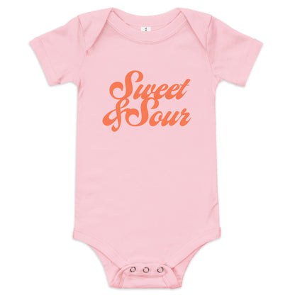 Chunky Deli product image: "Sweet and Sour" onesie (100% cotton, pink color) laid flat on a white background, showcasing the envelope shoulders, short sleeves, three-snap closure, and the text "Sweet and Sour" in orange cursive font on the chest.