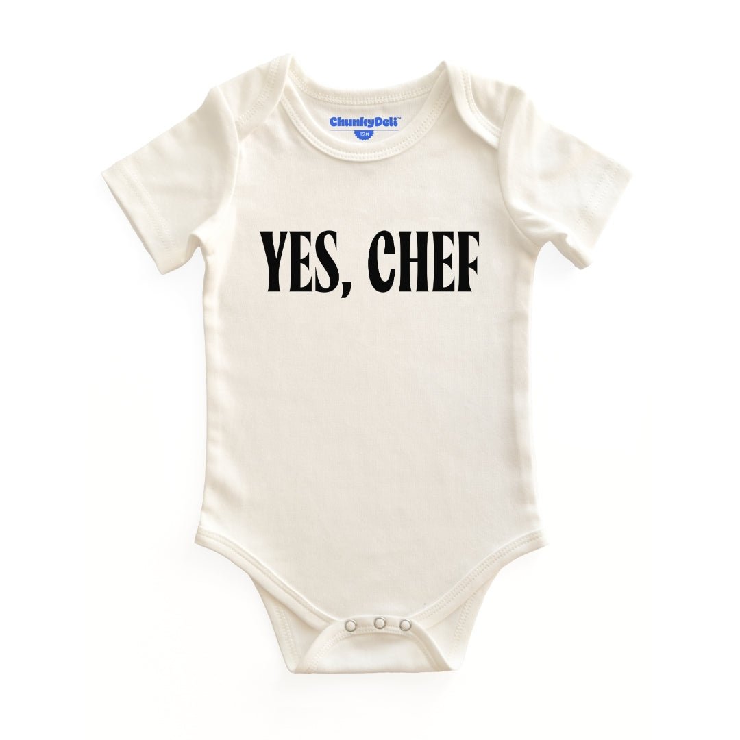Chunky Deli product image: Natural-colored "Yes, Chef!" bodysuit (100% cotton) laid flat on a white background, showcasing the envelope shoulders and three-snap closure.