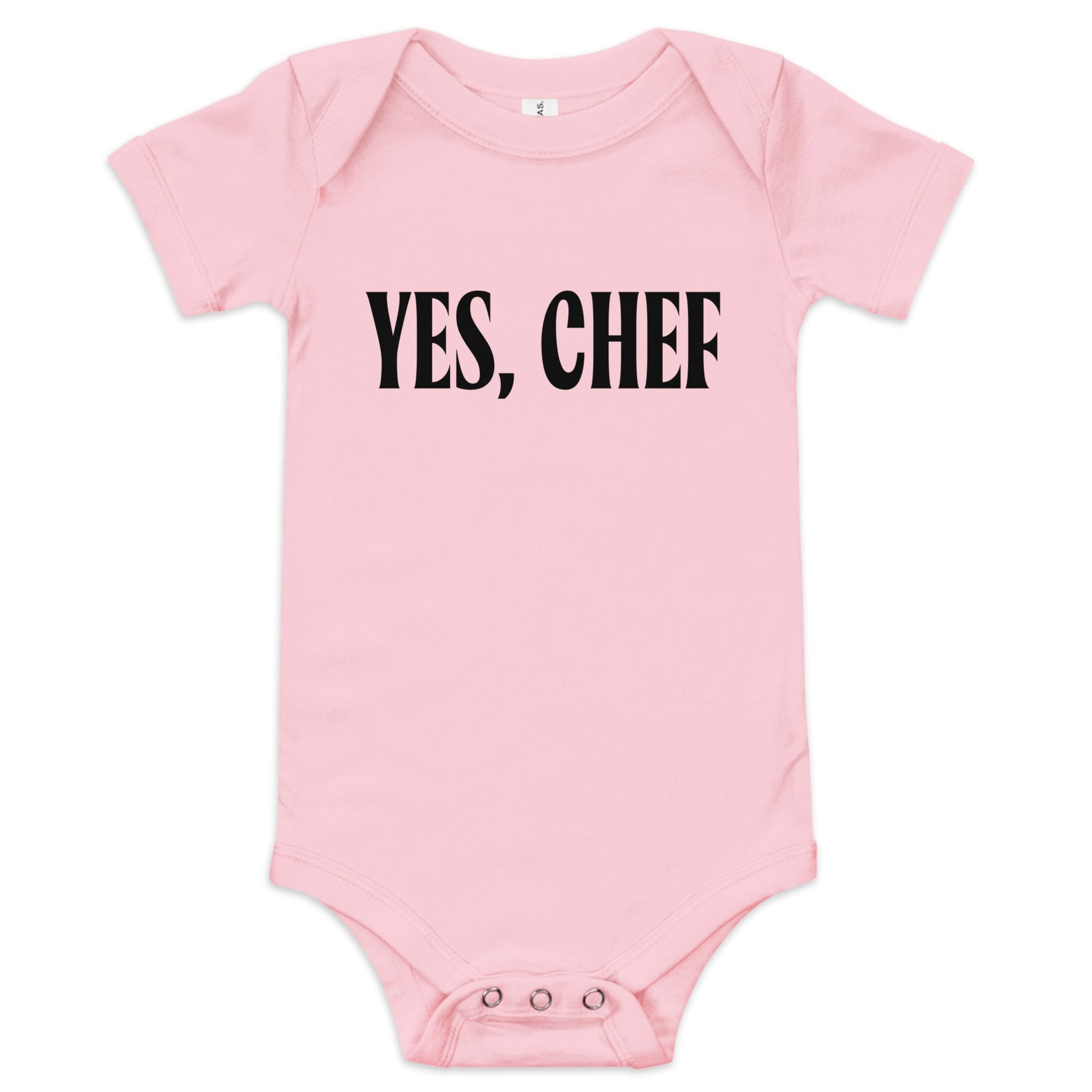  Chunky Deli product image: "Yes, Chef" onesie (100% cotton, pink color) laid flat on a white background, showcasing the envelope shoulders, short sleeves, three-snap closure, and the text "Yes, Chef" printed in black across the chest.